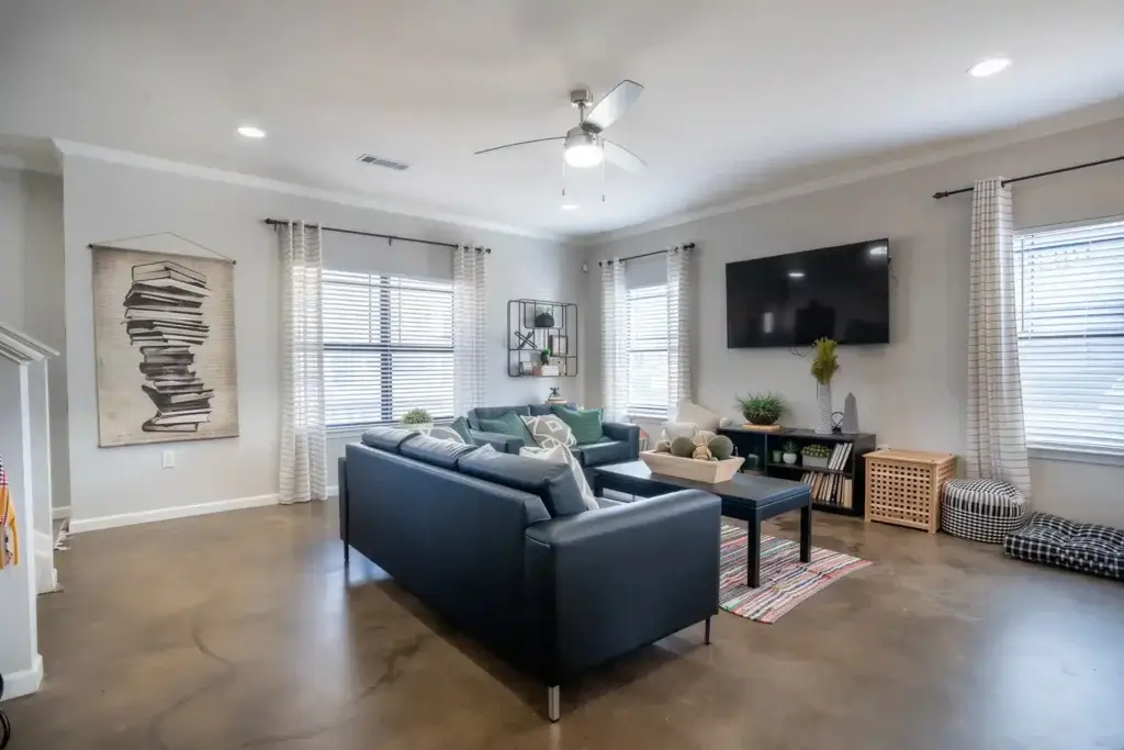 the collective at auburn apartments near auburn university spacious living room stained concrete flooring
