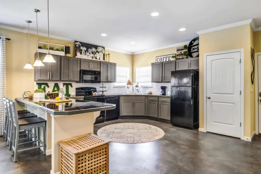 the collective at auburn luxury off campus cottage apartments near auburn university spacious kitchens with pantries granite countertops sleek black appliances 2